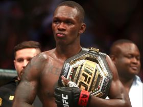 4:3 Israel Adesanya celebrates with the championship belt during UFC 263 at Gila River Arena. Mandatory Credit: Mark J. Rebilas-USA TODAY Sports