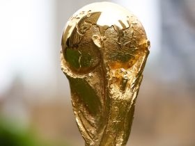 Jun 16, 2022; New York, New York, USA; The FIFA World Cup Trophy sits on a stand outside of 30 Rockefeller Plaza. Mandatory Credit: Jessica Alcheh-USA TODAY Sports