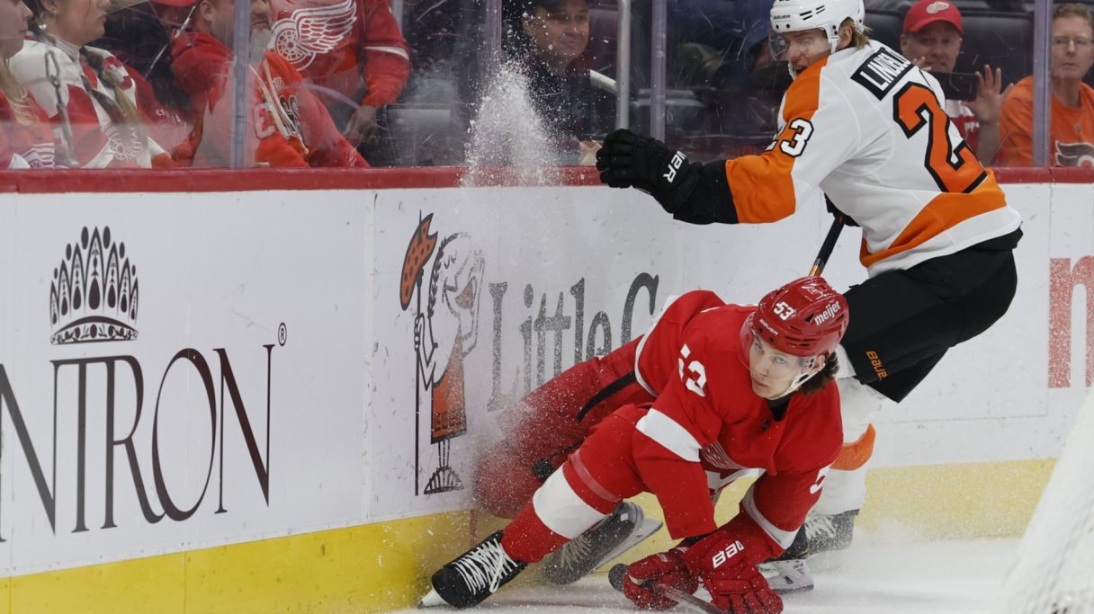 Moritz Seider (53) and Philadelphia Flyers left wing Oskar Lindblom (23) battle for the puck in the first period at Little Caesars Arena. Mandatory Credit: Rick Osentoski-USA TODAY Sports