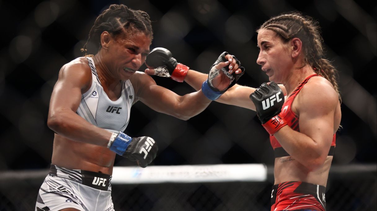 Tecia Torres (red gloves) fights Angela Hill (blue gloves) during UFC 265 at Toyota Center. Mandatory Credit: Troy Taormina-USA TODAY Sports