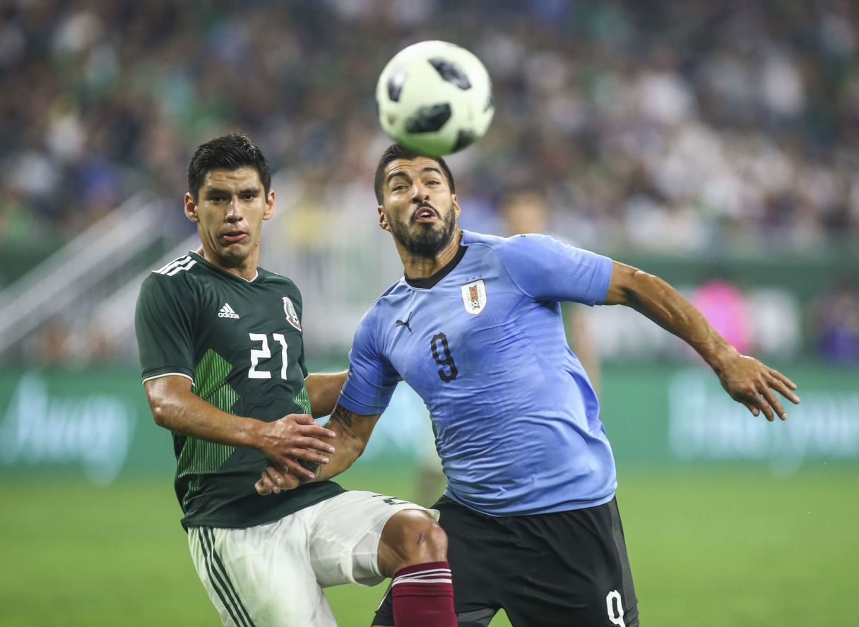 Uruguay forward Luis Suarez battles with Mexico's Jesus Angulo. © Troy Taormina-USA TODAY Sports