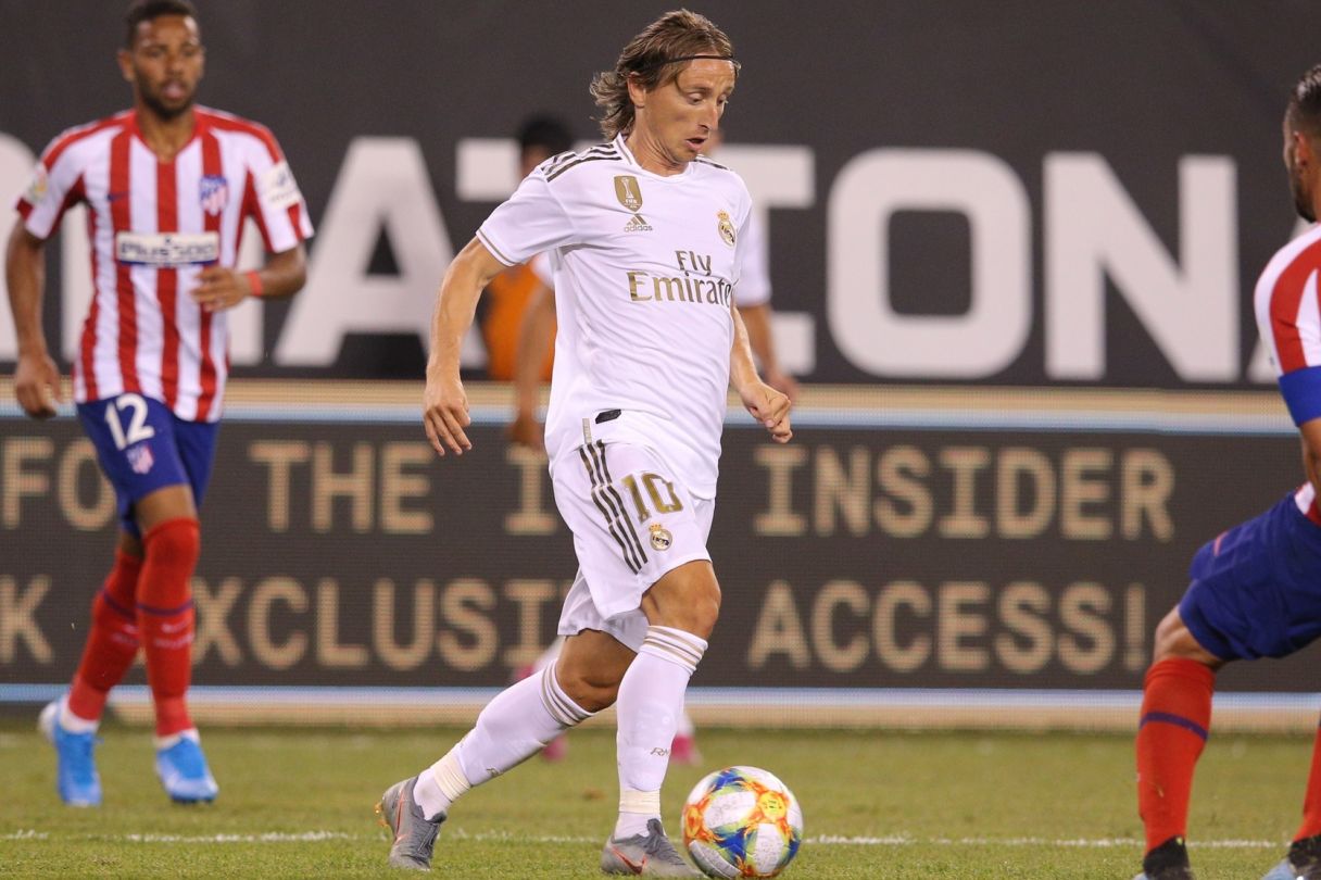 Luka Modric (10) dribbles the ball against Atletico de Madrid midfielder Koke (6). © Brad Penner-USA TODAY Sports