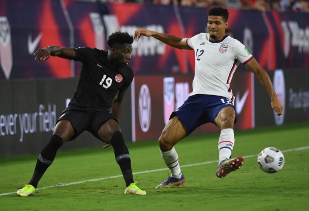 Alphonso Davies (L) in action against the USA